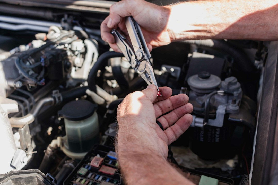 a-man-is-working-on-a-car-engine-haqk9odokmu